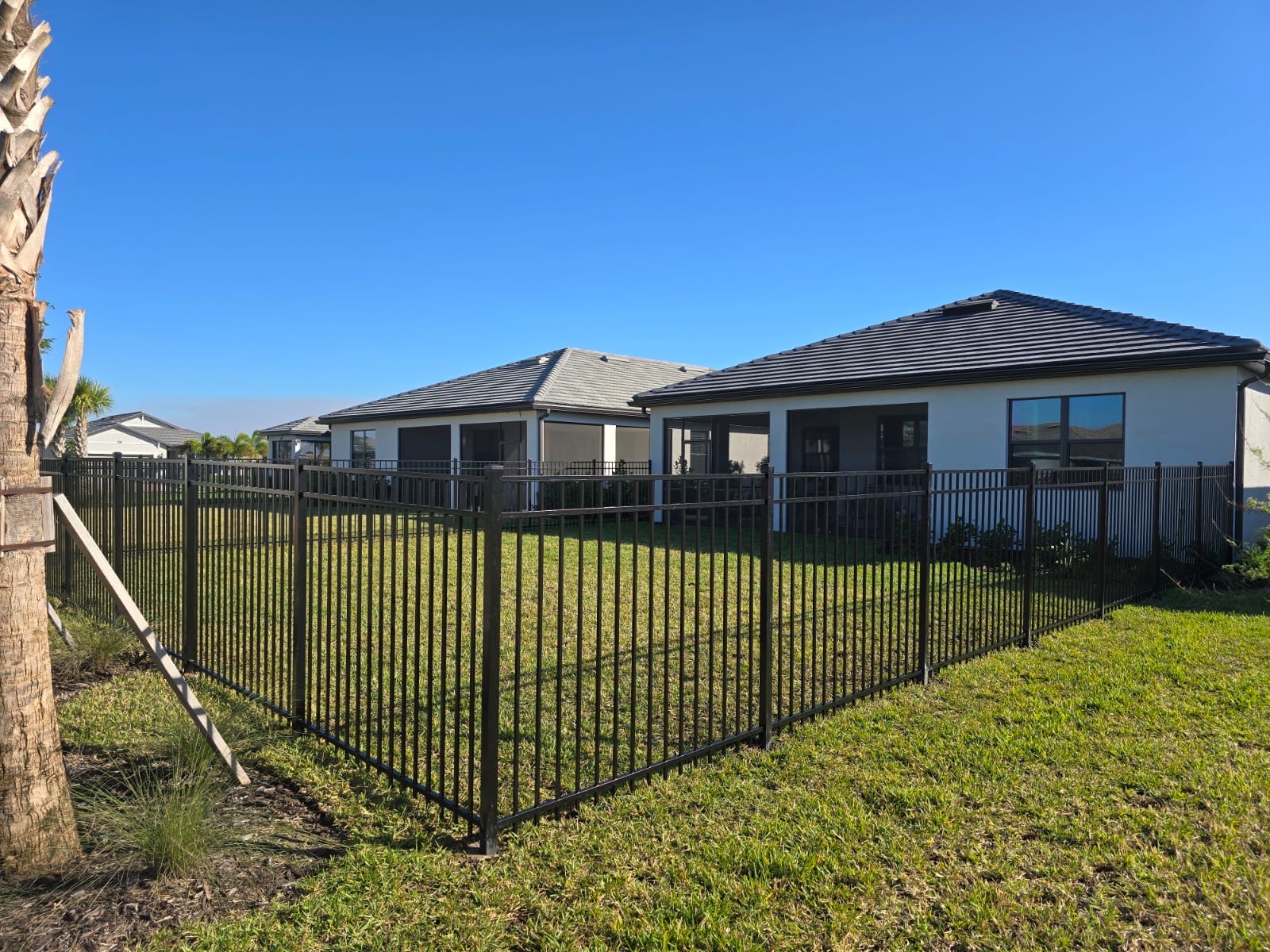 Black aluminum backyard fence installed by Southern Hoss Fences